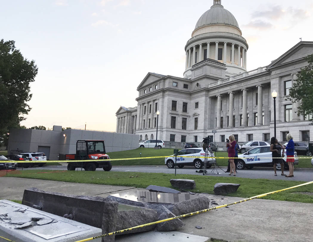The new Ten Commandments monument outside the state Capitol in Little Rock, Ark., is blocked off Wednesday morning, June 28, 2017, after someone crashed into it with a vehicle, less than 24 hours  ...