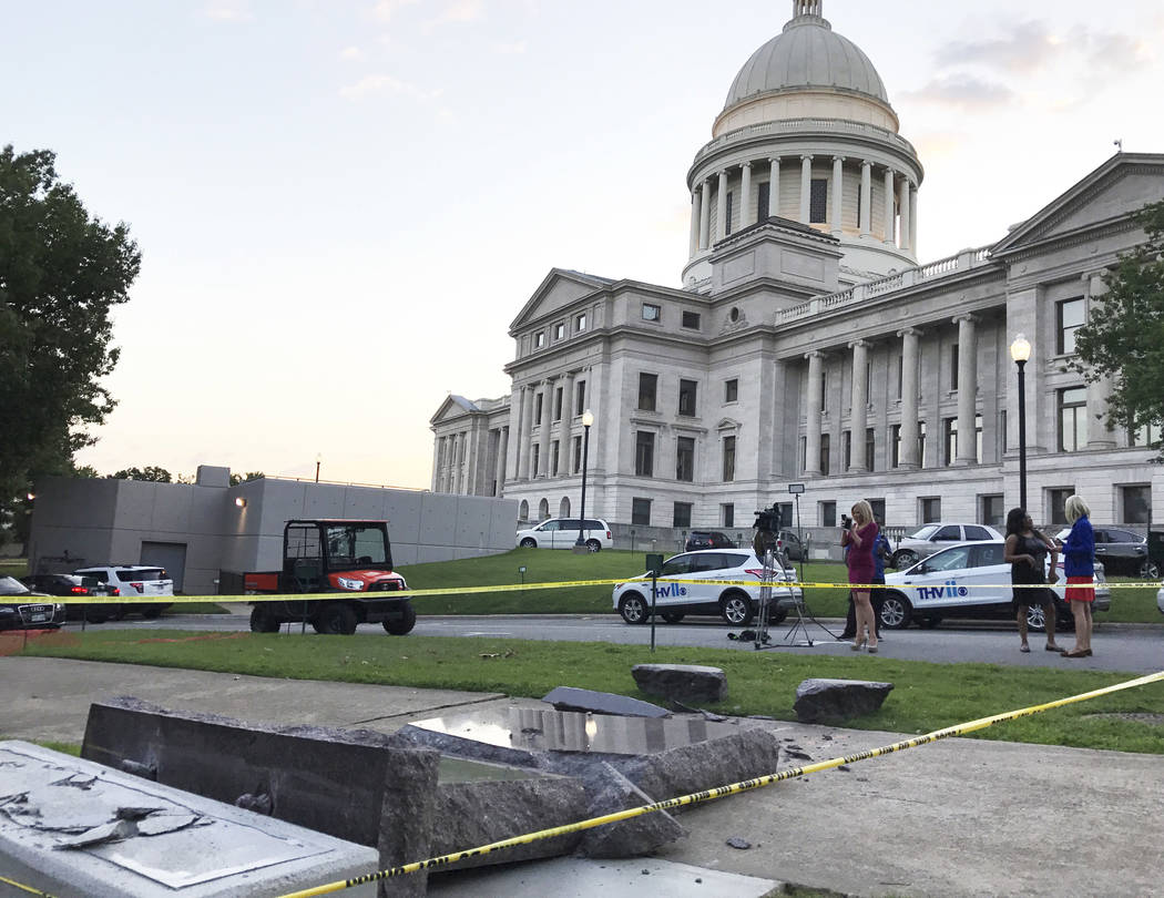 The new Ten Commandments monument outside the state Capitol in Little Rock, Ark., is blocked off Wednesday morning, June 28, 2017, after someone crashed into it with a vehicle, less than 24 hours ...
