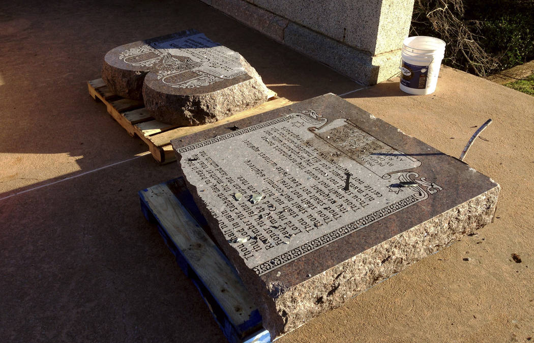 The damaged remains of a Ten Commandments monument lie on the state Capitol grounds on Oct. 24, 2014, in Oklahoma City after driver, Michael Tate Reed of Van Buren, Ark., crashed into the statue.  ...