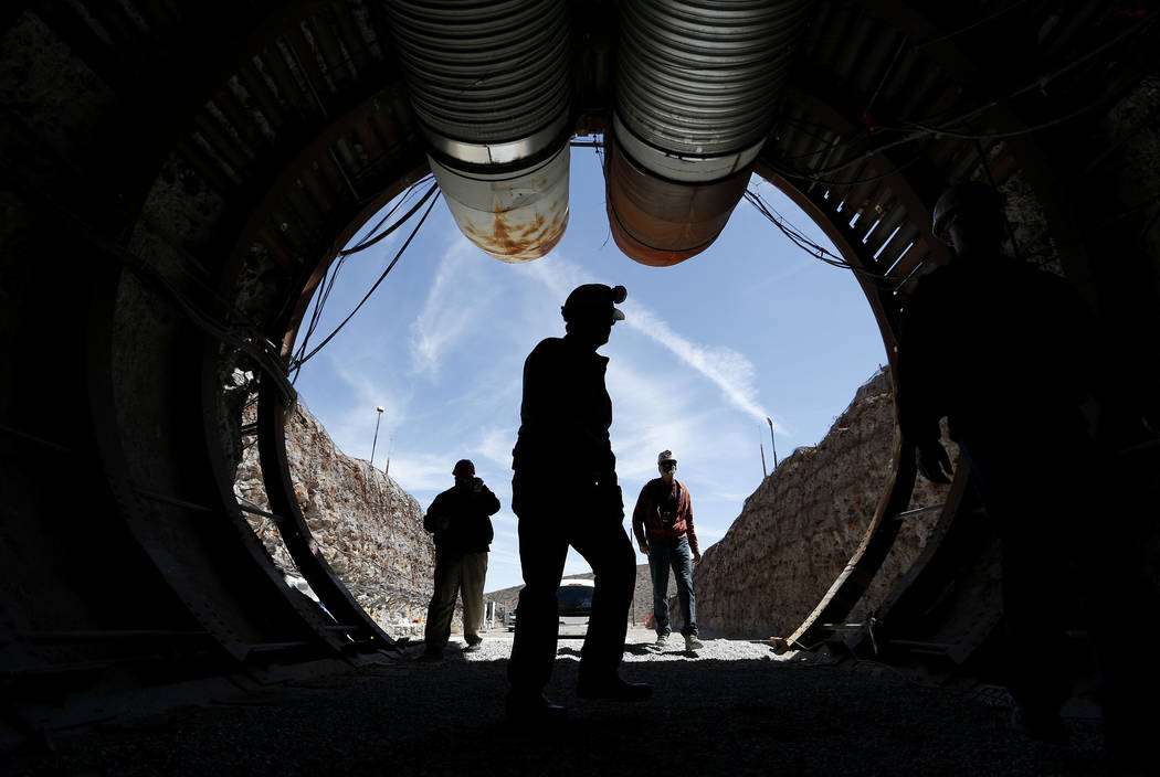 In this April 9, 2015, file photo, people walk into the south portal of Yucca Mountain during a congressional tour of the proposed radioactive waste dump near Mercury, Nev., 90 miles northwest of  ...
