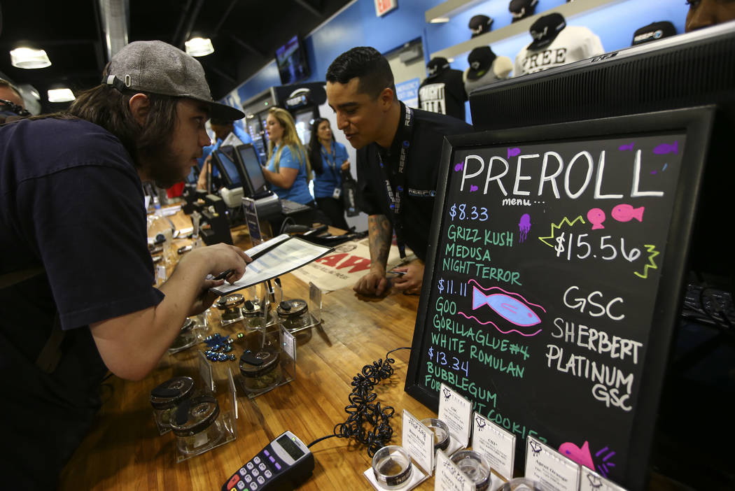 A customer looks through marijuana items as recreational sales become legal in Nevada at Reef Dispensaries in Las Vegas on Saturday, July 1, 2017. Chase Stevens Las Vegas Review-Journal @csstevens ...