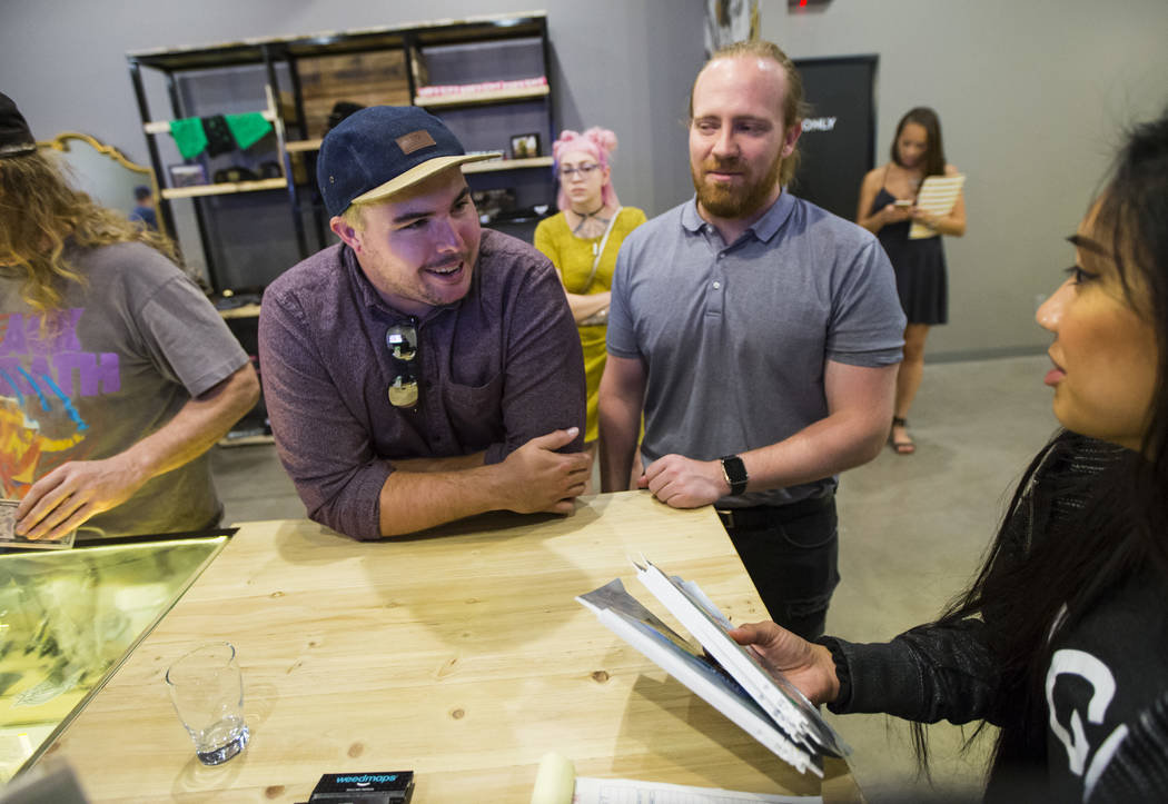 Jake Schlei, left, and Stephen Ward, both of Las Vegas, browse through edible marijuana products during the first day of recreational sales at Acres Cannabis in Las Vegas on Saturday, July 1, 2017 ...