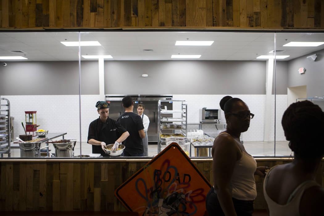 Brian Orr, left, works on making edible marijuana products in the kitchen area at Acres Cannabis during the first day of recreational sales in Las Vegas on Saturday, July 1, 2017. Chase Stevens La ...