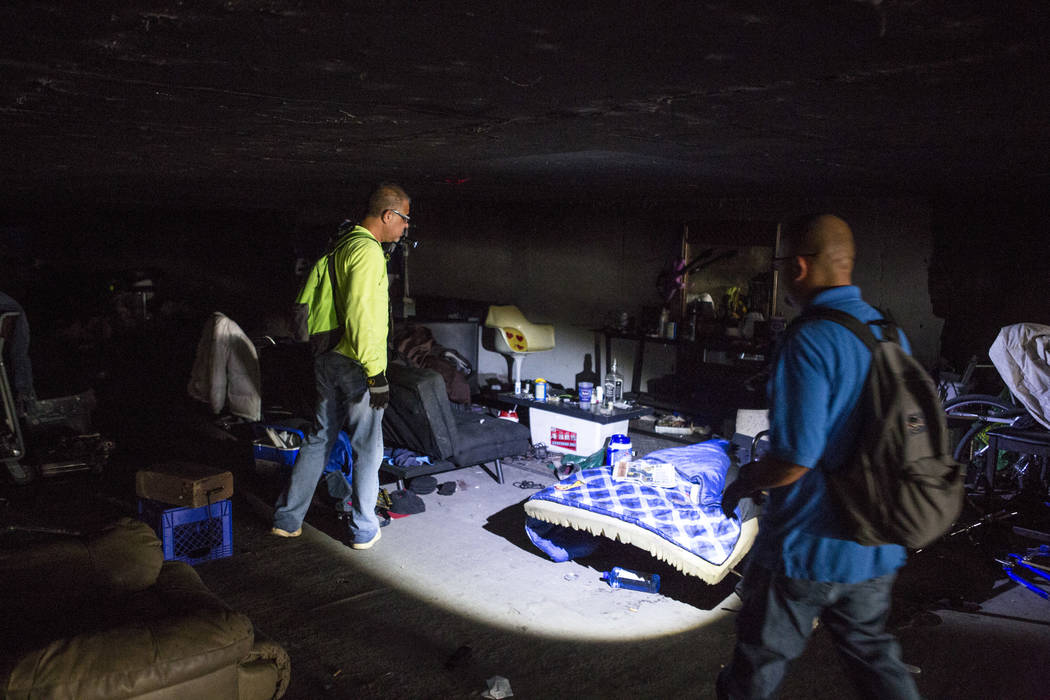HELP of Southern Nevada employees Louis Lacey, left, and Oscar Landgrabe check out a vacant bed and makeshift coffee table in a flood tunnel near the Hard Rock hotel-casino on Tuesday, June 27, 20 ...