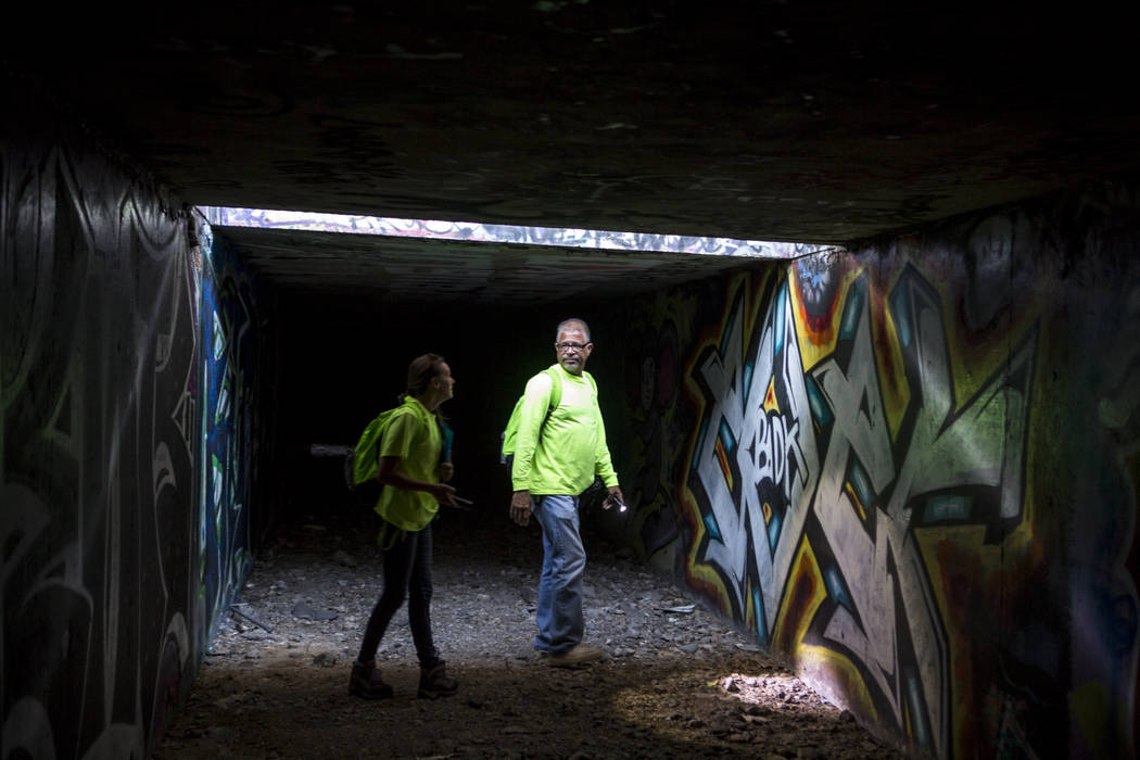 HELP of Southern Nevada employees Louis Lacey and Hayli Petcoff pause in a patch of light underneath Interstate 15 in a flood tunnel near the Hard Rock hotel-casino on Tuesday, June 27, 2017.  Pat ...