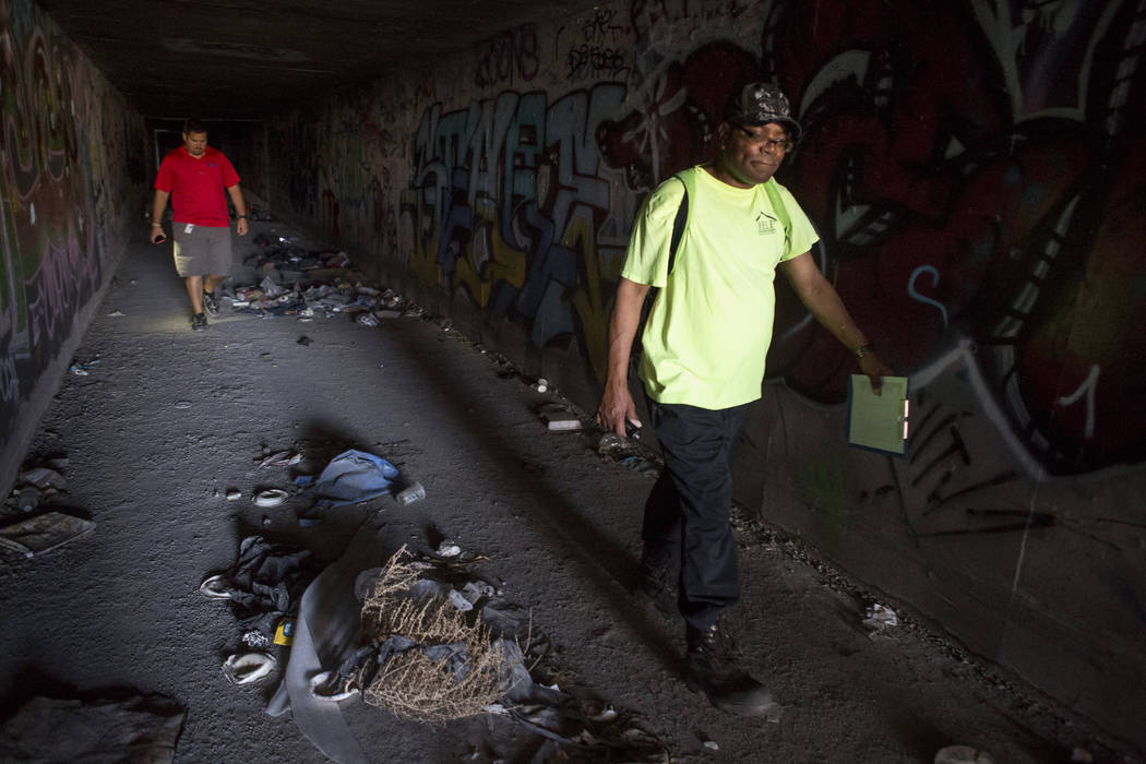 HELP of Southern Nevada employee Walter Poston, right, a Mobile Crisis Intervention Team outreach specialist, walks through a flood tunnel while a U.S. Vets team member follows near the Rio hotel- ...