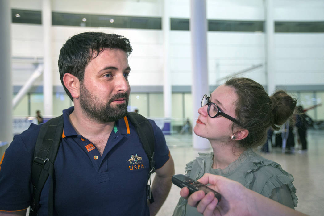 Khaled Almilaji and his wife, Jehan Mouhsen, speak to a reporter after reuniting at Pearson International Airport near Toronto, June 16, 2017. Almilaji, who coordinated a campaign that vaccinated ...