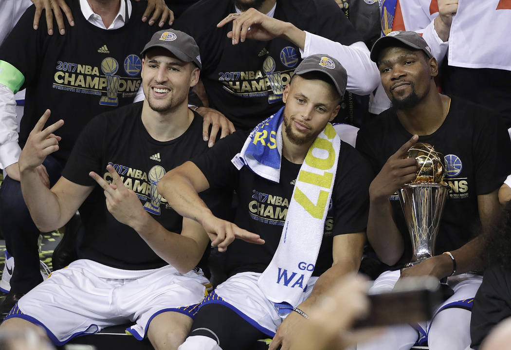 Golden State Warriors guard Klay Thompson, from left, guard Stephen Curry and forward Kevin Durant celebrate after Game 5 of the NBA Finals against the Cleveland Cavaliers. (AP Photo/Marcio Jose S ...