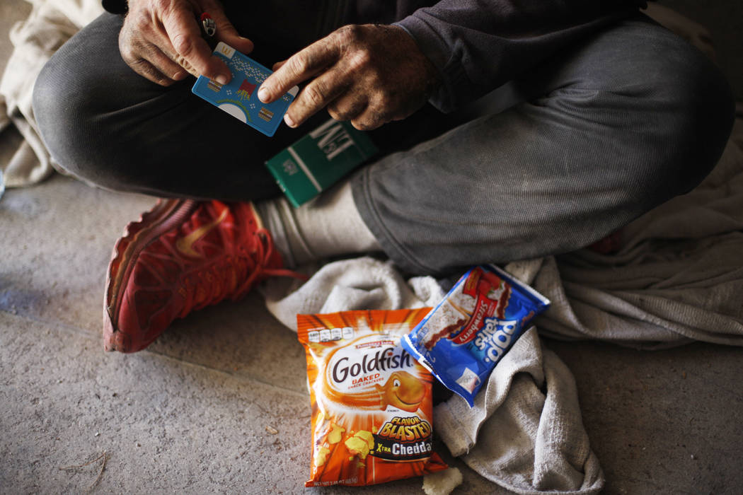 Cory holds goods that Matthew O'Brien brought him in the flood tunnels on Tuesday, May 16, 2017, in Las Vegas. O'Brien spent years interviewing the hundreds of people that live there, eventually w ...