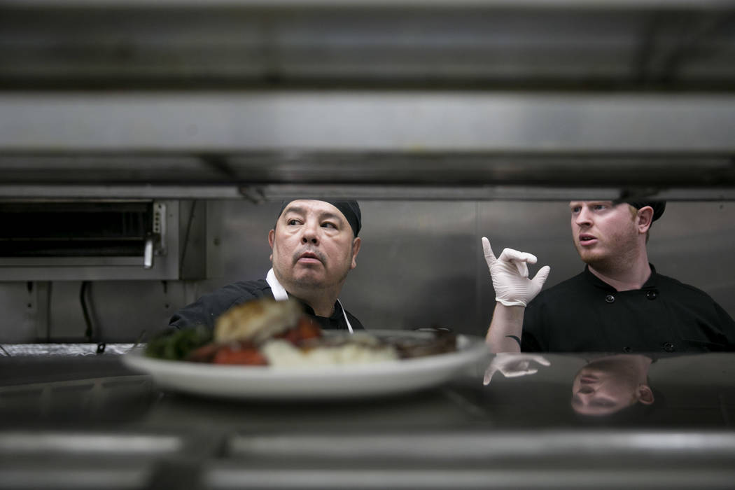 From left: Randy Gonsales, second lead, and Chris Scaduto, line cook, check orders during lobster and steak night at the Club Fortune Casino in Henderson, Wednesday, June 14, 2017. Gabriella Angot ...