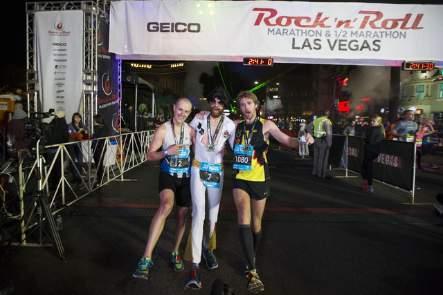 Top three runners from left,  Chip O'hara, who finished third, Michael Wardian, who finished first, and Eric Fitzpatrick who finished second, pose after the Rock-n-Roll Marathon at the Strip near  ...