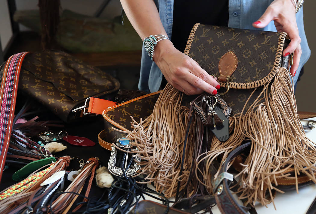 Co-owner of New Vintage, Stephanie Ponder, demonstrates how to make old designer handbags new again by decorating them in a trendy, bohemian way on Friday, June 30, 2017, in Las Vegas. Bizuayehu T ...