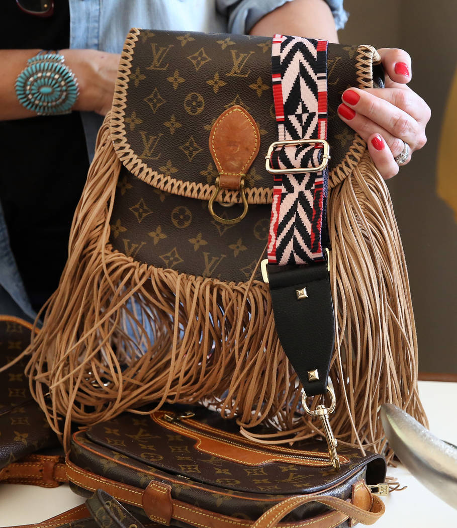 Co-owner of New Vintage, Stephanie Ponder, demonstrates how to make old designer handbags new again by decorating them in a trendy, bohemian way on Friday, June 30, 2017, in Las Vegas. Bizuayehu T ...