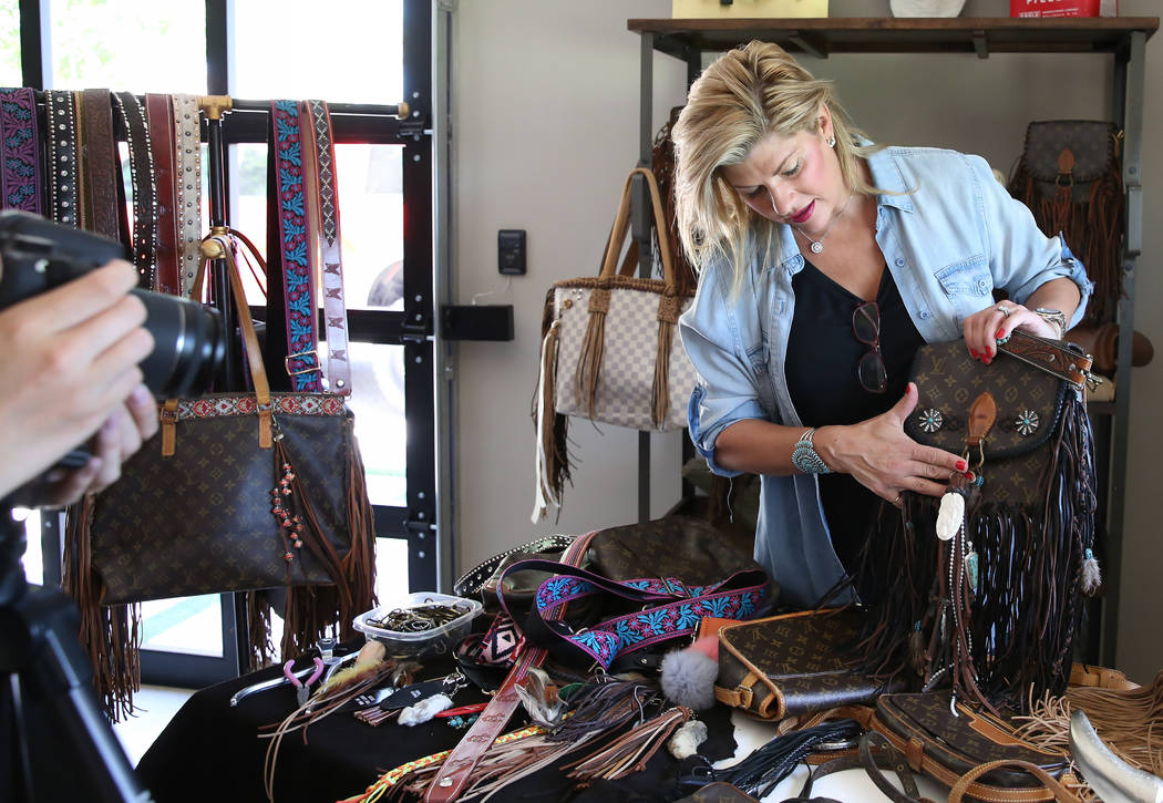 Co-owner of New Vintage, Stephanie Ponder, demonstrates how to make old designer handbags new again by decorating them in a trendy, bohemian way on Friday, June 30, 2017, in Las Vegas. Bizuayehu T ...
