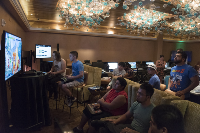 Ashton Beliveau, left, and Steven Linakis, second from left,  compete in the Street Fighter V tournament at the Downtown Underground e-sports lounge at Downtown Grand hotel-casino in Las Vegas on  ...