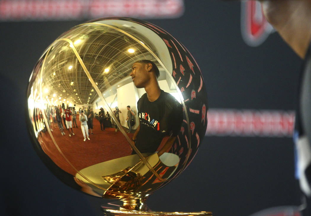 A boy looks at the Larry O'Brien Trophy that was on display during