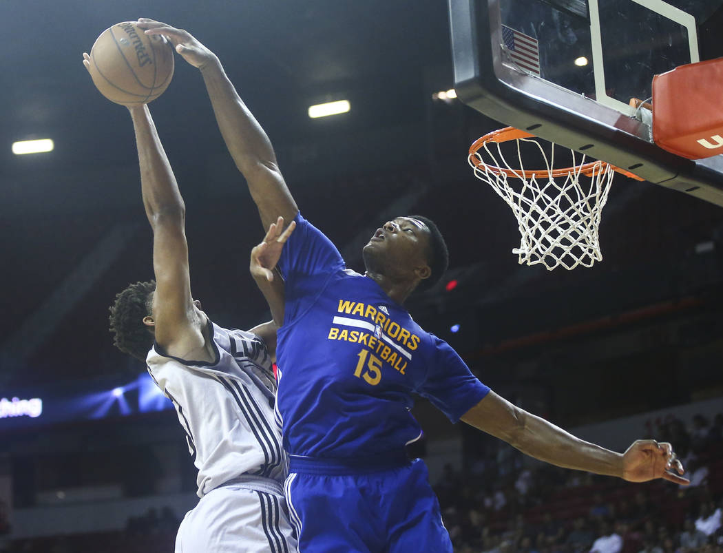 Golden State Warriors' Damian Jones (15) blocks a shot from Los Angeles Clippers' Isaiah Hicks (37) during a basketball game at the NBA Summer League at the Thomas & Mack Center in Las Vegas o ...
