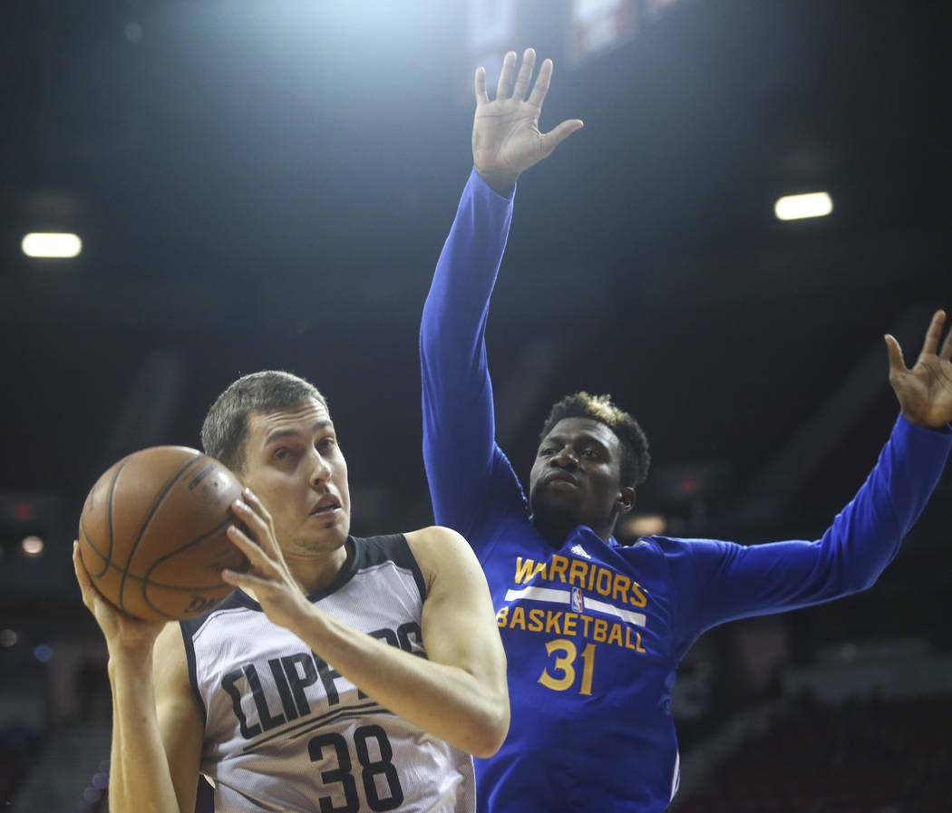 Los Angeles Clippers' Kyle Wiltjer (38) gets a rebound in front of Golden State Warriors' Dylan Ennis (31) during a basketball game at the NBA Summer League at the Thomas & Mack Center in Las ...
