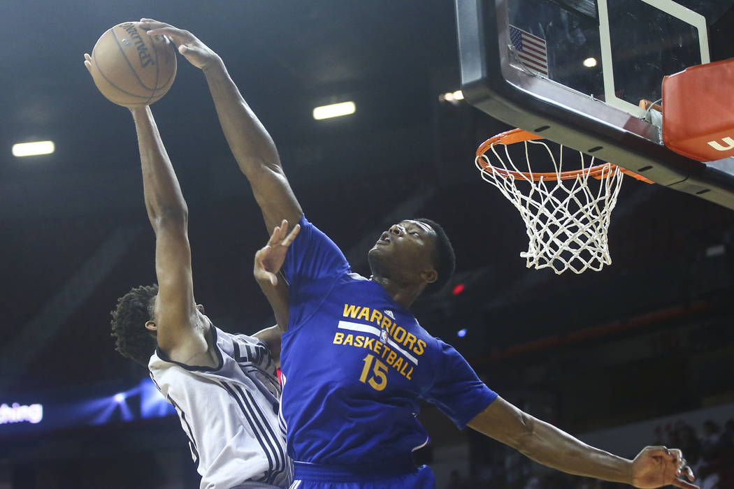 Golden State Warriors' Damian Jones (15) blocks a shot from Los Angeles Clippers' Isaiah Hicks (37) during a basketball game at the NBA Summer League at the Thomas & Mack Center in Las Vegas o ...