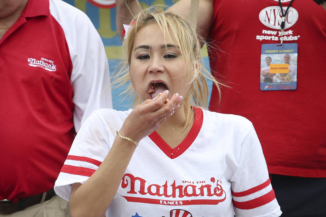 Miki Sudo competes at the Nathan's Famous Fourth of July International Hot Dog Eating contest at Coney Island, Friday, July 4, 2014, in New York. Sudo defeated the reigning champion Sonya Thomas b ...