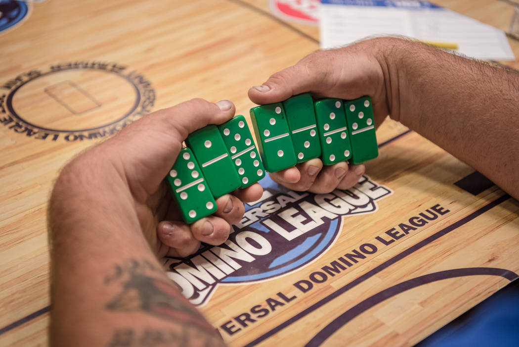 Jared Roberts takes a look at his choice of dominoes at the Summer Slam Domino Tournament hosted by the The Universal Domino League at Westgate hotel-casino on Saturday, July 8, 2017, in Las Vegas ...