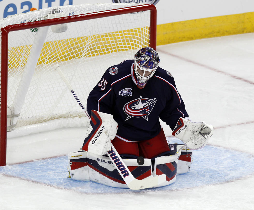 Columbus Blue Jackets' Oscar Dansk, of Sweden, stops a shot agains the St. Louis Blues during an NHL preseason hockey game in Columbus, Ohio, Sunday, Sept. 21, 2014. (AP Photo/Paul Vernon)