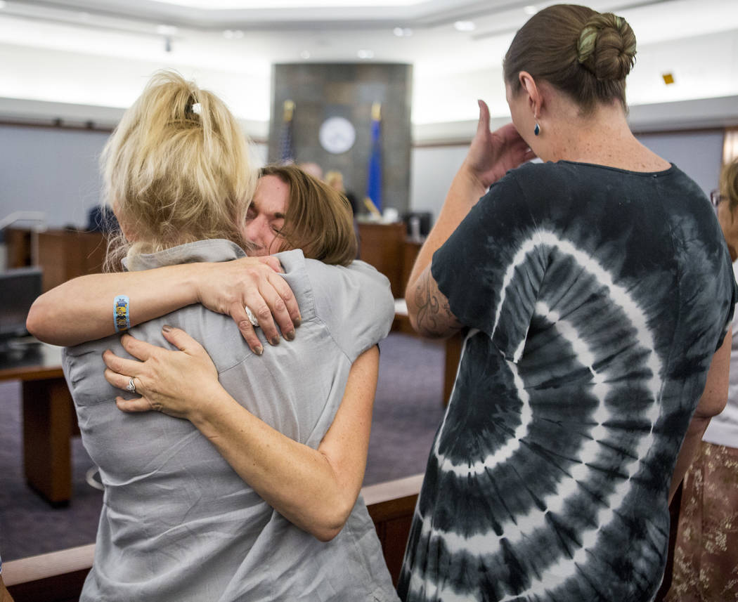 Colleen Beyer, center, the daughter of Sharon Randolph, is embraced after Thomas Randolph was sentenced to death by jurors during penalty phase of his murder trial at the Regional Justice Center i ...