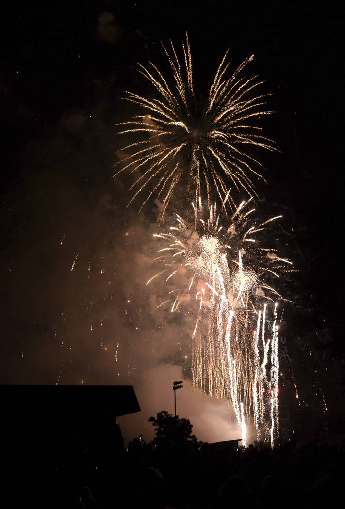 People watch fireworks at Graf Park over Wheaton, Ill., Monday July 3, 2017. (Mark Black/Daily Herald via AP)