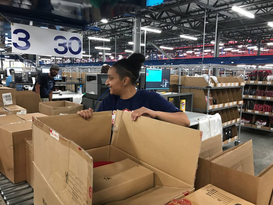 The first group of Fanatics employees have arrived inside the online retailer's distribution center in North Las Vegas. The retailer plans to hire about 200 people this summer. Fanatics