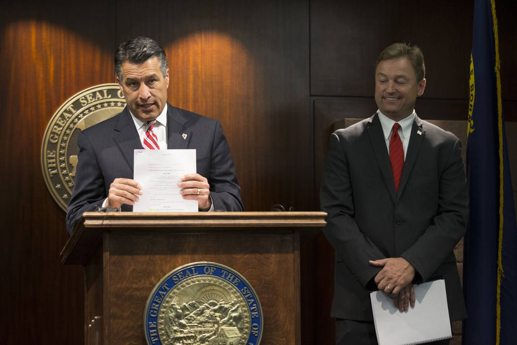 Nevada Gov. Brian Sandoval, left, and Sen. Dean Heller during a press conference where the senator announced he will vote no on the proposed GOP healthcare bill at the Sawyer Building on Friday, J ...