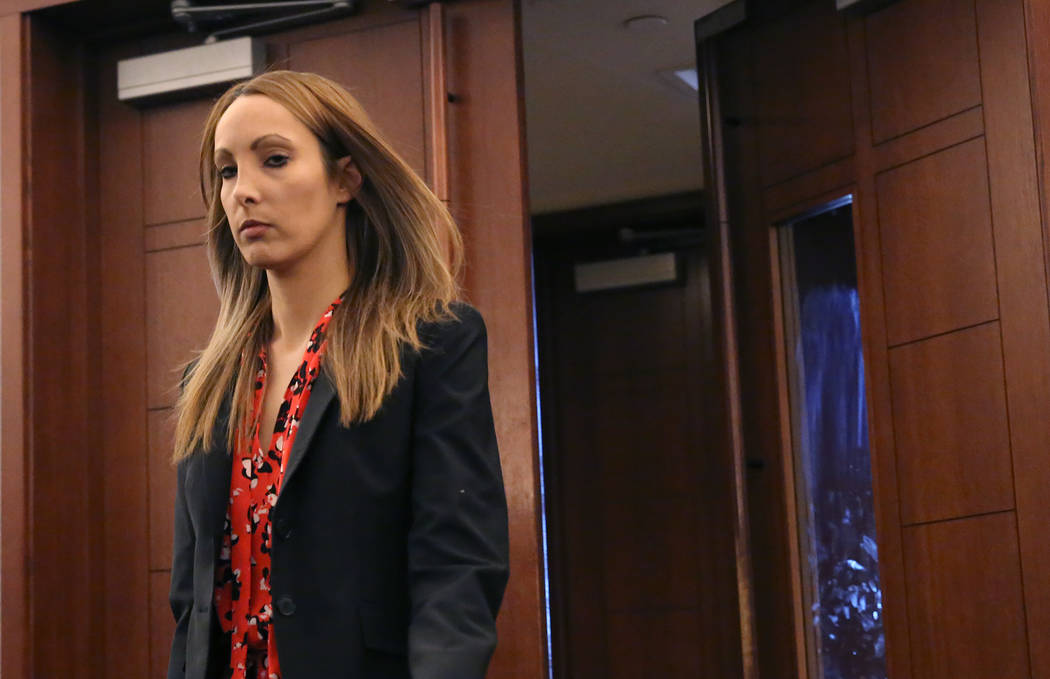 Alexis Plunkett, a criminal defense attorney facing a dozen felony charges for providing a cell phone to inmates at the Clark County Detention Center, enters the courtroom at the Regional Justice  ...