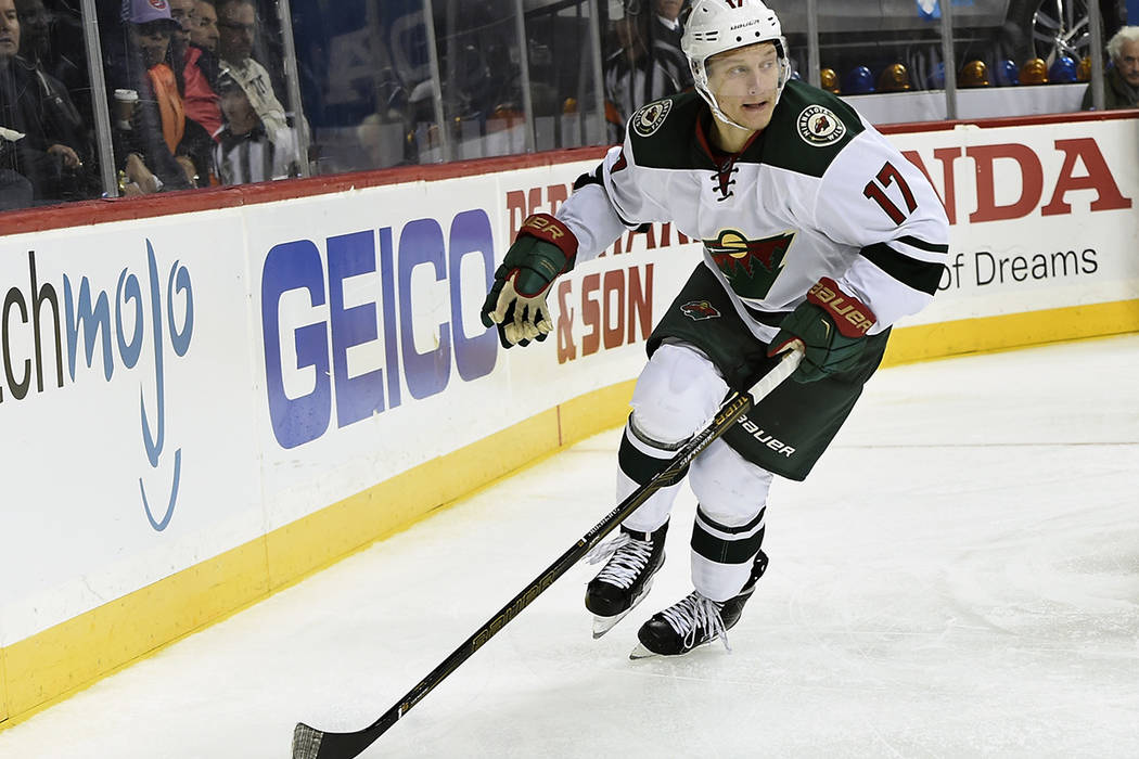 Minnesota Wild left wing Teemu Pulkkinen (17) looks to pass the puck in the third period of an NHL hockey game against the New York Islanders in New York, Sunday, Oct. 23, 2016. (AP Photo/Kathy Km ...