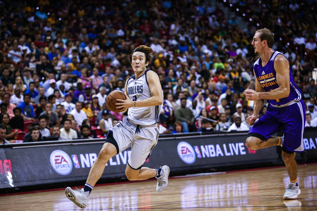 Dallas Mavericks forward Ding Yanyuhang heads toward the net against Los Angeles Lakers forward Brandon Ingram during the NBA Summer League semifinal game at Thomas and Mack Center on Sunday, July ...