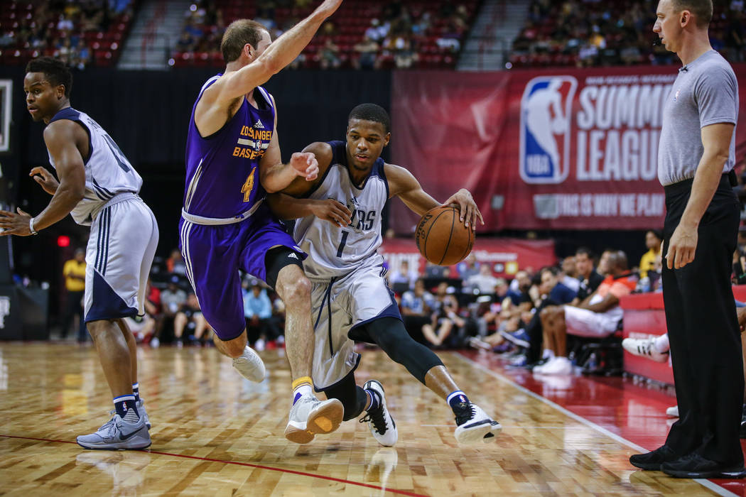 Dallas Mavericks guard Dennis Smith Jr. takes the ball down the court against Los Angeles Lakers guard Alex Caruso during the NBA Summer League semifinal game at Thomas and Mack Center on Sunday,  ...
