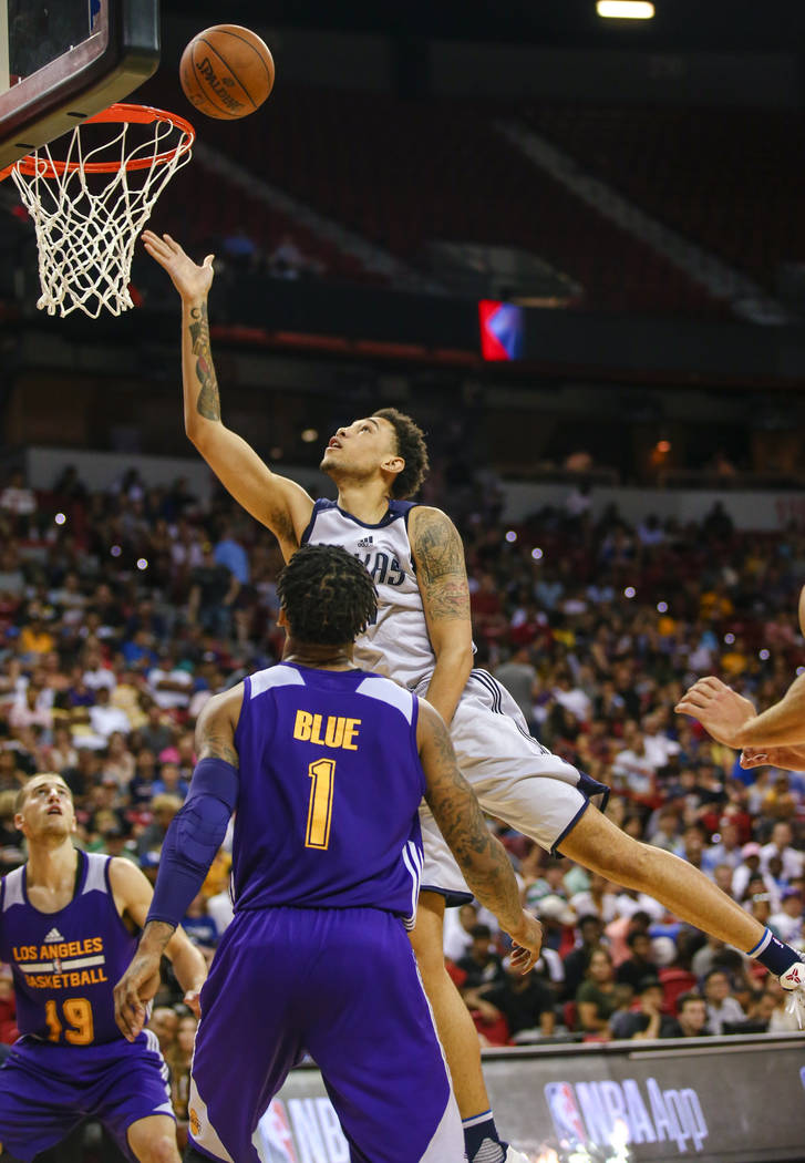 Dallas Mavericks forward Brandon Ashley with the ball against Los Angeles Lakers guard Vader Blue and Los Angeles Lakers guard Matt Thomas during the NBA Summer League semifinal game at Thomas and ...