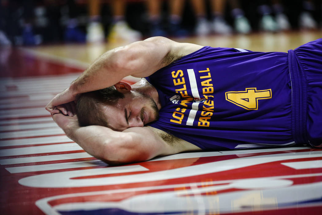 Los Angeles Lakers guard Alex Caruso takes a moment to himself after being knocked over during the NBA Summer League semifinal game at Thomas and Mack Center on Sunday, July 16, 2017, in Las Vegas ...