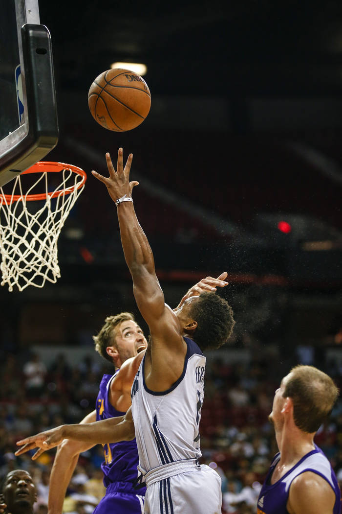 Dallas Mavericks guard Yogi Ferrell attempting to save the shot against Los Angeles Lakers forward Travis Wear during the NBA Summer League semifinal game at Thomas and Mack Center on Sunday, July ...