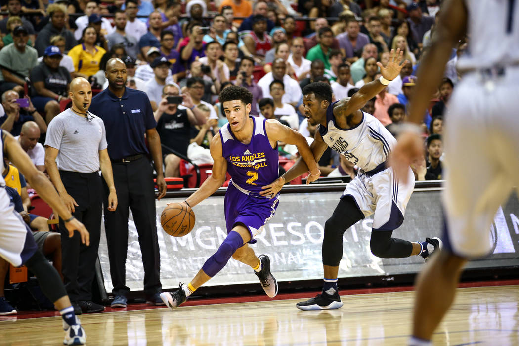 Los Angeles Lakers guard Lonzo Ball goes up against Dallas Mavericks forward Carrick Felix during the NBA Summer League semifinal game at Thomas and Mack Center on Sunday, July 16, 2017, in Las Ve ...