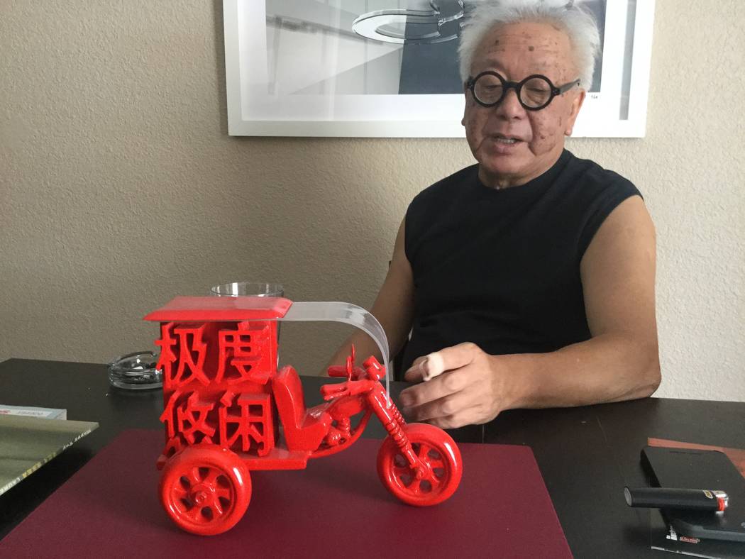 Artist Laurens Tan explains his mixed media sculpture called "Beng Beng" in his home on July 5, 2017. The title stands for the sound three-wheel carts in rural China make while transporting people ...