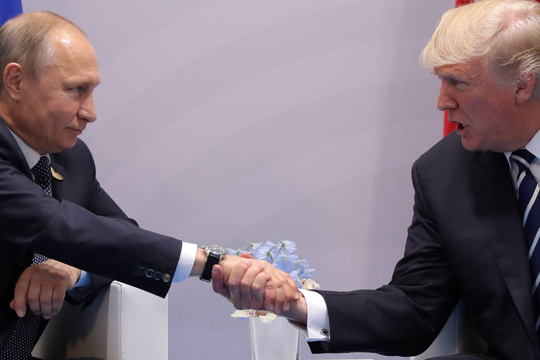 U.S. President Donald Trump shakes hands with Russian President Vladimir Putin during their bilateral meeting at the G20 summit in Hamburg, Germany July 7, 2017. REUTERS/Carlos Barria