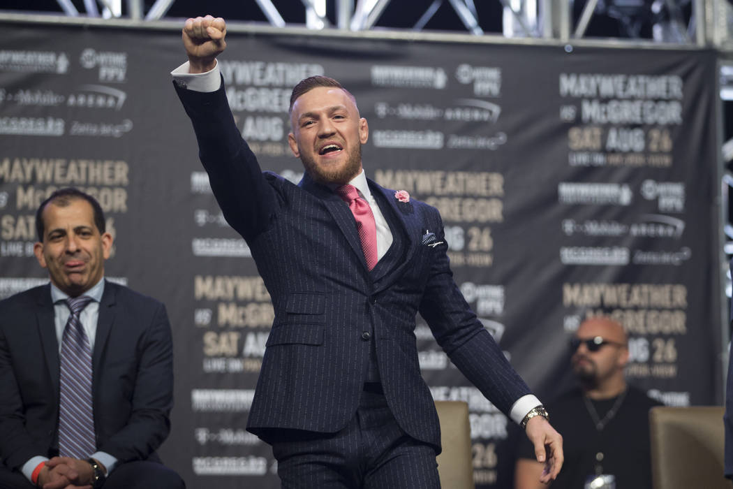 UFC fighter Conor McGregor, center, during a world tour event stop to promote his upcoming fight against Boxer Floyd Mayweather Jr., at Staples Center in Los Angeles, Calif., on Tuesday, July 11,  ...