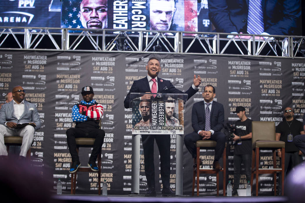 UFC fighter Conor McGregor, center, during a world tour event stop to promote his upcoming fight against Boxer Floyd Mayweather Jr., at Staples Center in Los Angeles, Calif., on Tuesday, July 11,  ...