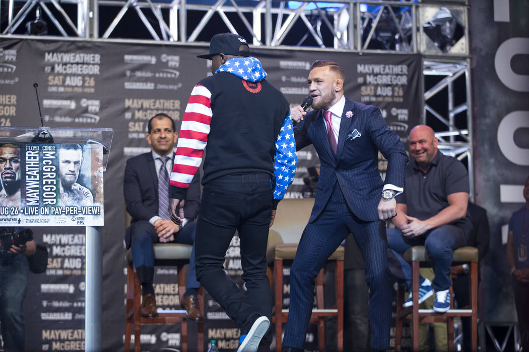 Boxer Floyd Mayweather Jr., left, and UFC fighter Conor McGregor, during a world tour event stop to promote their upcoming fight, at Staples Center in Los Angeles, Calif., on Tuesday, July 11, 201 ...
