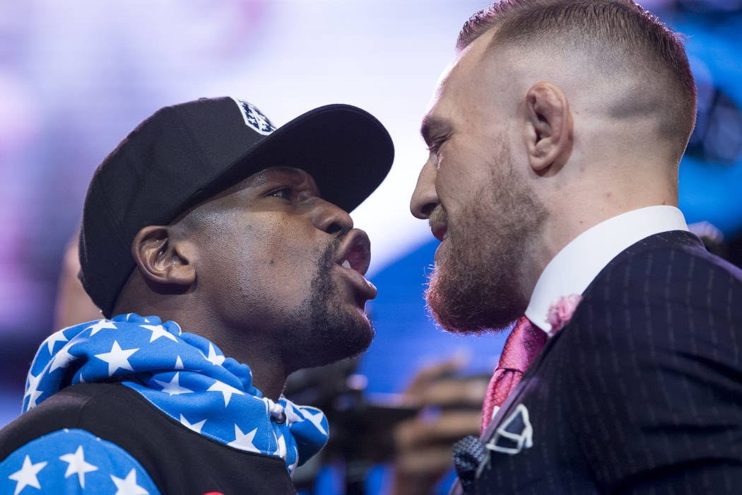 Boxer Floyd Mayweather Jr., left, and UFC fighter Conor McGregor, during a world tour event stop to promote their upcoming fight, at Staples Center in Los Angeles, Calif., on Tuesday, July 11, 201 ...