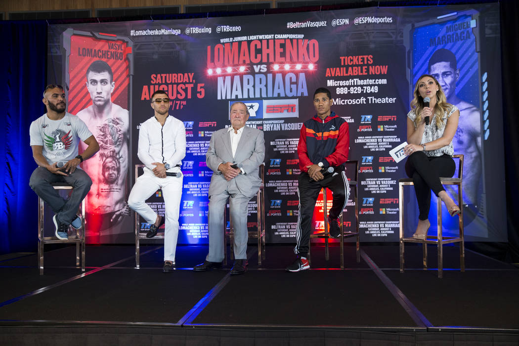 Boxers Raymundo Beltran, from left, Vasyl Lomachenko, Miguel Marriaga, fourth from left, promoter Bob Arum, third from left, and reporter Crystina Poncher during a press conference in Los Angeles, ...