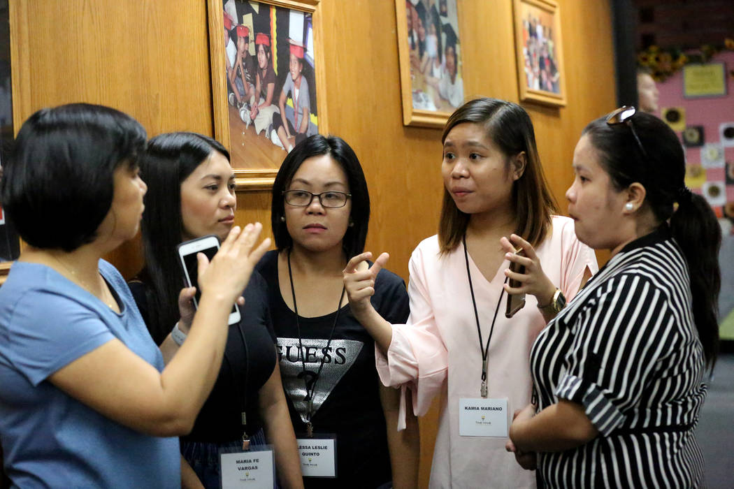 Clark County School District Director of Employee Contracts and Compensation Joyce Herreria, from left, answers questions from Maria Fe M. Vargas, Lesie Quinto, Kamia Mariano and Marielle Castro b ...