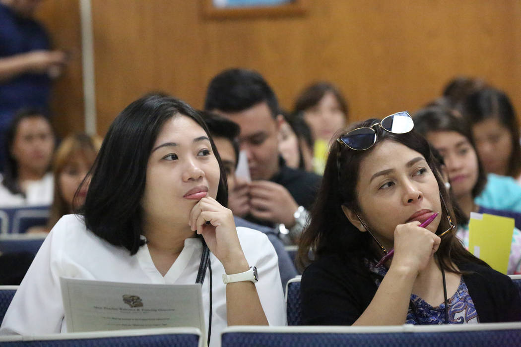 Amy Irene Salayog, left, and Gina Mejia listen during the orientation on Tuesday, July 11, 2017 of over 70 teachers that the Clark County School District brought in from the Philippines to fill a  ...
