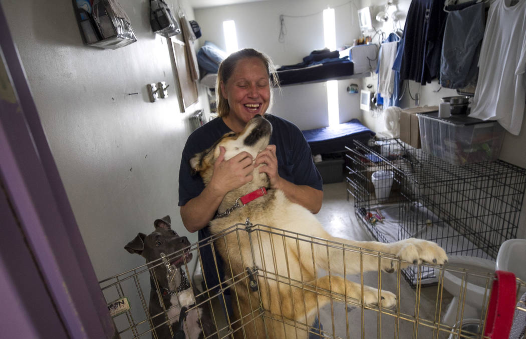 Inmate Erika Valenzuela stands inside her cell room with her dogs Kino, center, and Nalla inside the Pups on Parole cell block at the Florence McClure Women's Correctional Center in Las Vegas on T ...