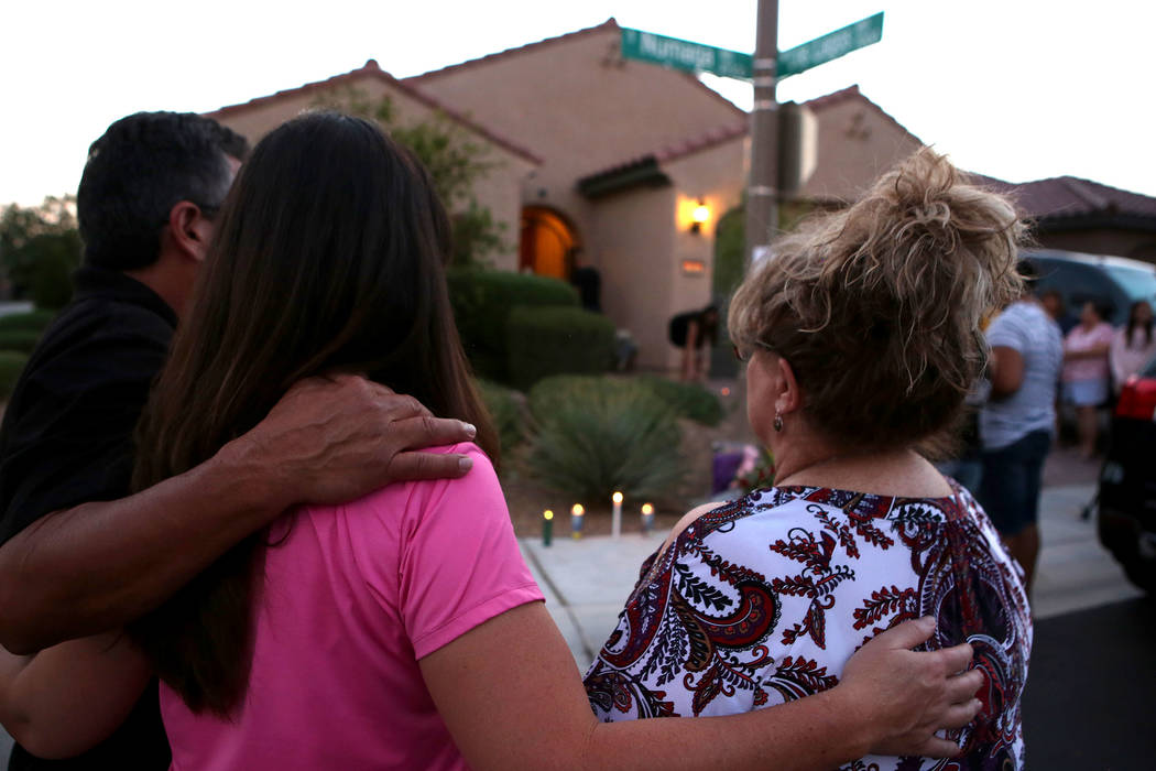 Attendees gather to mourn on the 10300 block of Numaga Road in Las Vegas, Tuesday, July 11, 2017, during a vigil for the family killed in Monday night's murder-suicide.  Bridget Bennett Las Vegas  ...