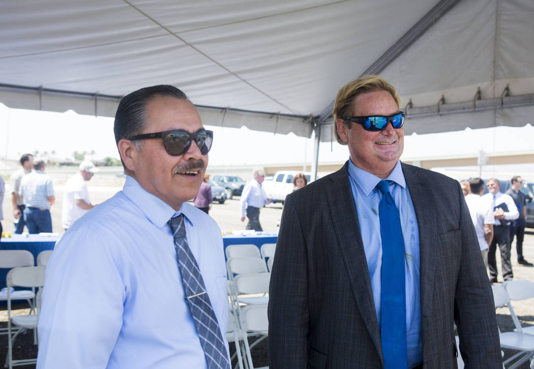 The Nevada Department of Transportation director Rudy Malfabon, left, and NDOT spokesman Tony Illia talk during a celebration to mark the opening of the Centennial Bowl flyover bridge linking west ...